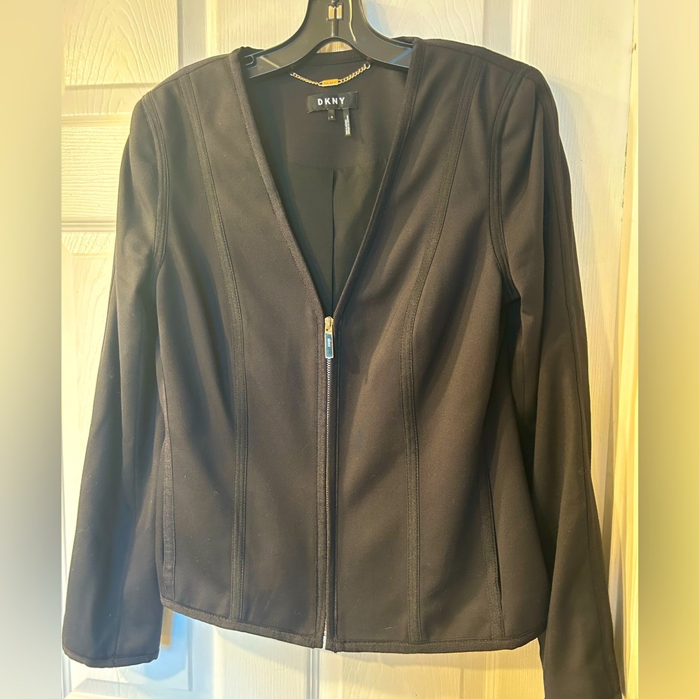 Classic black, fully-lined DKNY jacket with side pockets.